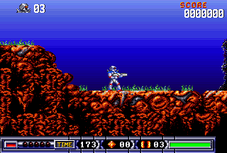 Turrican II level 1: the player in silver armour standing on orange rock under the blue gradient sky, HUD showing five lives, TIME 173, score zero