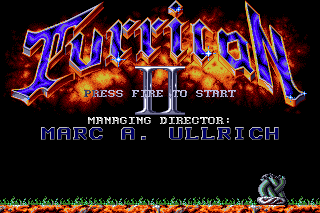 The Turrican II title screen: the blue chrome logo surrounded by flames, PRESS FIRE TO START, and the credits scroller